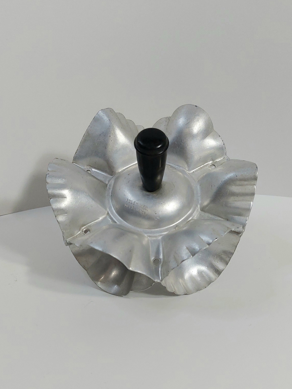 Foley 1950s Aluminum Foley rolling cookie and pastry cutter with black handles.